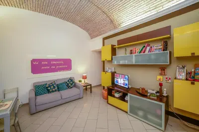 a living room with a couch and a tv at Casa Di Camilla in Rome