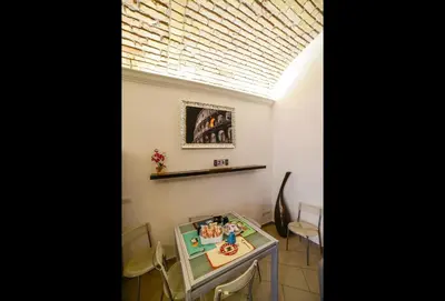 a dining room with a table with a cake on it at Casa Di Camilla in Rome