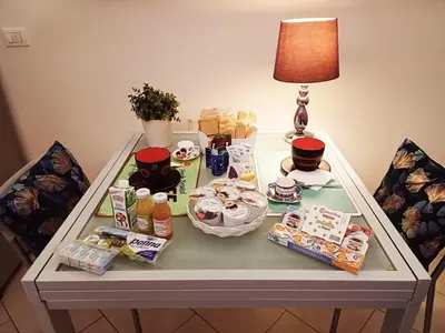 a table with food and a lamp on it at Casa Di Camilla in Rome