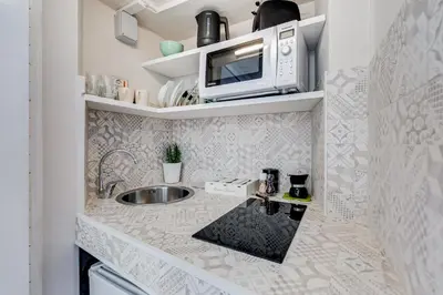 a small kitchen with a sink and a microwave at Romantic Studio with Balcony near Navona Square in Rome