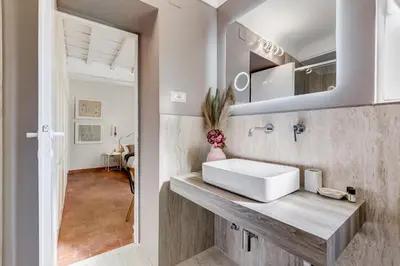 a bathroom with a white sink in a room at Romantic Studio with Balcony near Navona Square in Rome