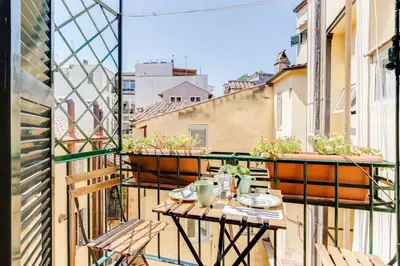 a balcony with a table and chairs on a balcony at Romantic Studio with Balcony near Navona Square in Rome