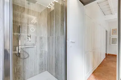 a shower with a glass door in a bathroom at Romantic Studio with Balcony near Navona Square in Rome