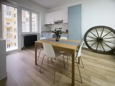 a kitchen and dining room with a wooden table and chairs at Cecilia s House in Rome