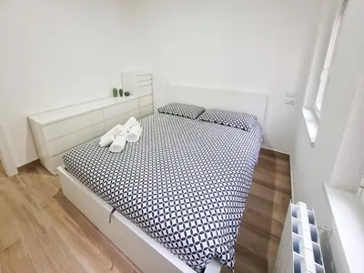 a bedroom with a bed with black and white sheets at Cecilia s House in Rome