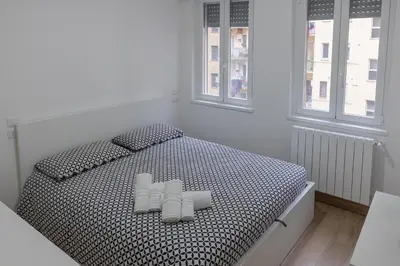 a bedroom with a black and white bed with two pillows at Cecilia s House in Rome