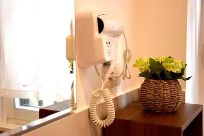 a phone on a wall next to a vase with flowers at B&B CasaBentivoglio in Rome