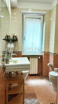 a bathroom with a sink and a toilet and a window at B&B CasaBentivoglio in Rome