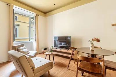a living room with a table and a tv at iFlat Warm & Welcoming Little Gem in Rione Monti in Rome