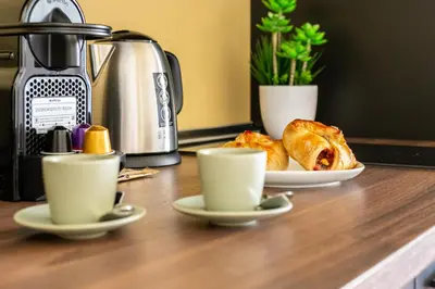 two cups of coffee and pastries on a counter at iFlat Warm & Welcoming Little Gem in Rione Monti in Rome