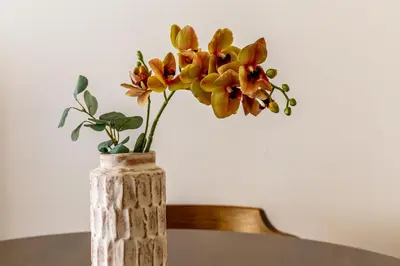 a vase with flowers in it on a table at iFlat Warm & Welcoming Little Gem in Rione Monti in Rome