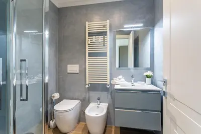 a bathroom with a toilet and a sink and a shower at iFlat Stylish New Flat Steps from the Vatican in Rome