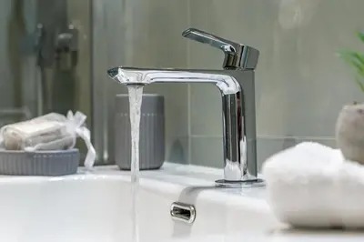a bathroom sink with water running from a faucet at iFlat Stylish New Flat Steps from the Vatican in Rome
