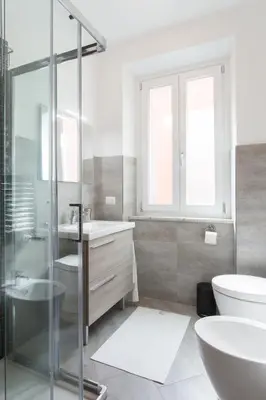 a bathroom with a shower and a toilet and a sink at Domenichino Luxury Home in Rome