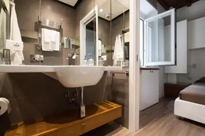 a bathroom with a sink and a mirror at Domenichino Luxury Home in Rome