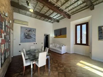 a dining room with a glass table and white chairs at La Dolce Vita in the Ancient Rome in Rome