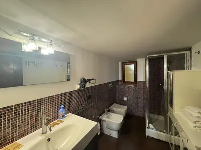 a bathroom with a sink and a toilet and a mirror at La Dolce Vita in the Ancient Rome in Rome