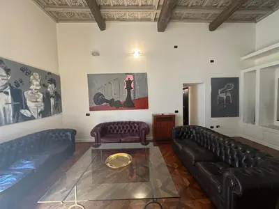 a living room with two leather couches and a table at La Dolce Vita in the Ancient Rome in Rome