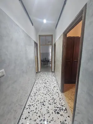 a hallway with white walls and a tile floor at Roma centro little house of testaccio in Rome