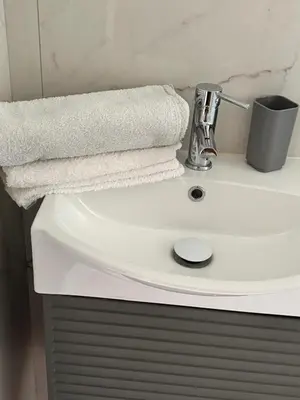 a white bathroom sink with a towel on it at Roma centro little house of testaccio in Rome