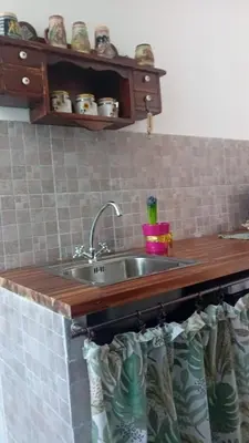 a kitchen with a sink and a wooden counter top at Roma centro little house of testaccio in Rome