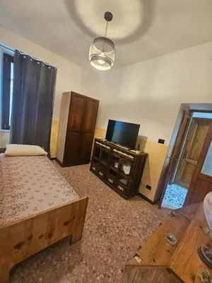 a living room with a bed and a flat screen tv at Roma centro little house of testaccio in Rome