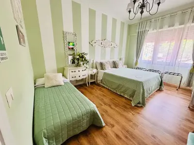 a bedroom with two beds and a mirror at Mami Guest House Rome Vatican St Peters in Rome
