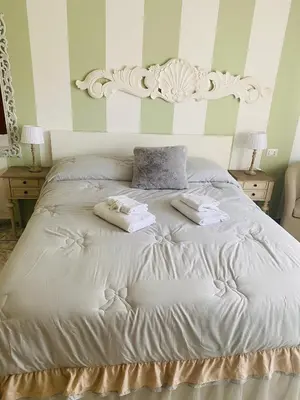 a white bed with two folded towels on it at Mami Guest House Rome Vatican St Peters in Rome