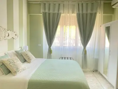 a bedroom with a large white bed and a window at Mami Guest House Rome Vatican St Peters in Rome