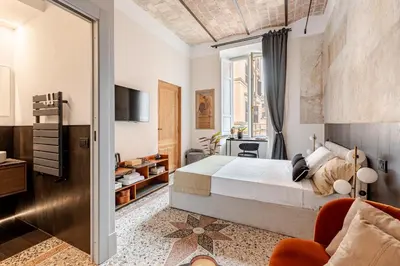 a bedroom with a bed and a living room at En-suite Bedroom Manin - 2 min walk to Termini Station in Rome