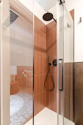 a shower with a glass door in a bathroom at En-suite Bedroom Manin - 2 min walk to Termini Station in Rome
