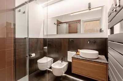 a bathroom with a toilet sink and a mirror at En-suite Bedroom Manin - 2 min walk to Termini Station in Rome