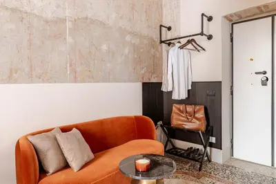 a living room with a couch and a table at En-suite Bedroom Manin - 2 min walk to Termini Station in Rome