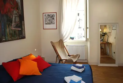 a bedroom with a bed with towels on it at Appartamento Piazza Farnese in Rome