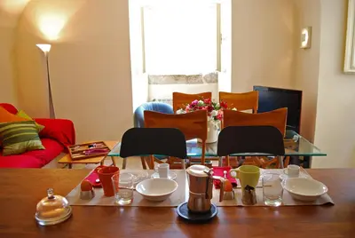 a living room with a table with dishes on it at Appartamento Piazza Farnese in Rome