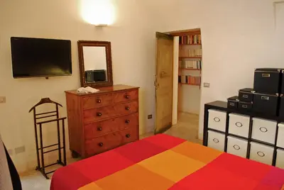 a bedroom with a bed and a dresser and a mirror at Appartamento Piazza Farnese in Rome