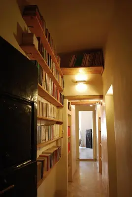 a hallway with bookshelves and a hallway with a hallway at Appartamento Piazza Farnese in Rome