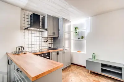 a kitchen with white appliances and a wooden counter top at Link Campus Apartment in Rome