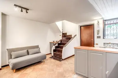 a living room with a couch and a staircase at Link Campus Apartment in Rome