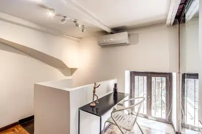 a dining room with a table and two chairs at Link Campus Apartment in Rome