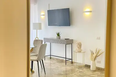 a living room with a table and a tv on a wall at 85mq of Vintage Luxury-Near Vatican City WIFI AC in Rome