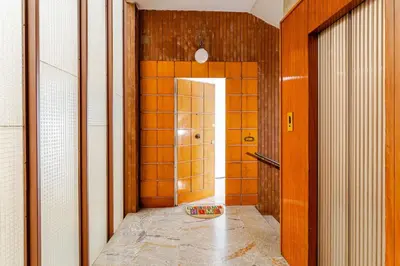 a bathroom with a walk in shower and a tile hallway at 85mq of Vintage Luxury-Near Vatican City WIFI AC in Rome