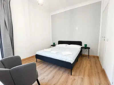 a bedroom with a bed and two chairs in it at Riboty Boutique Rooms in Rome