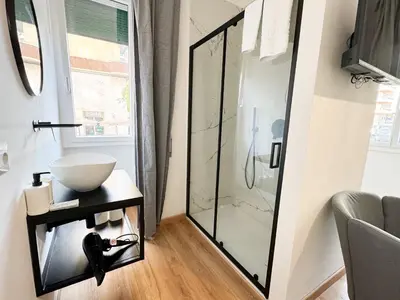 a bathroom with a sink and a glass shower at Riboty Boutique Rooms in Rome