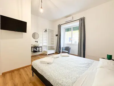 a bedroom with a bed and a window at Riboty Boutique Rooms in Rome