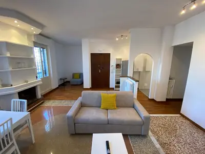 a living room with a couch and a yellow pillow at The 7th in Rome