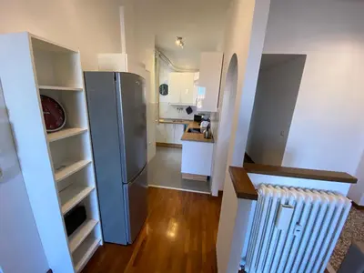 a kitchen with a stainless steel refrigerator in a room at The 7th in Rome
