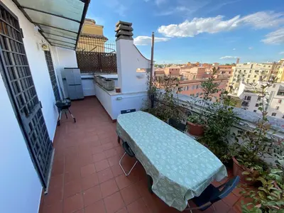a balcony with a table and a view of a city at The 7th in Rome