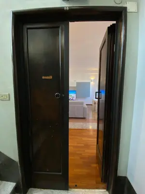 a black door in a room with a living room at The 7th in Rome
