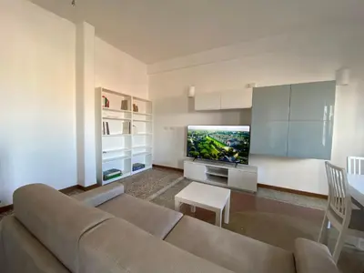 a living room with a couch and a flat screen tv at The 7th in Rome